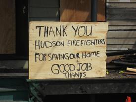 A sign posted on the front of 444 Carroll Street in Hudson the day after a potentially devastating fire at that location