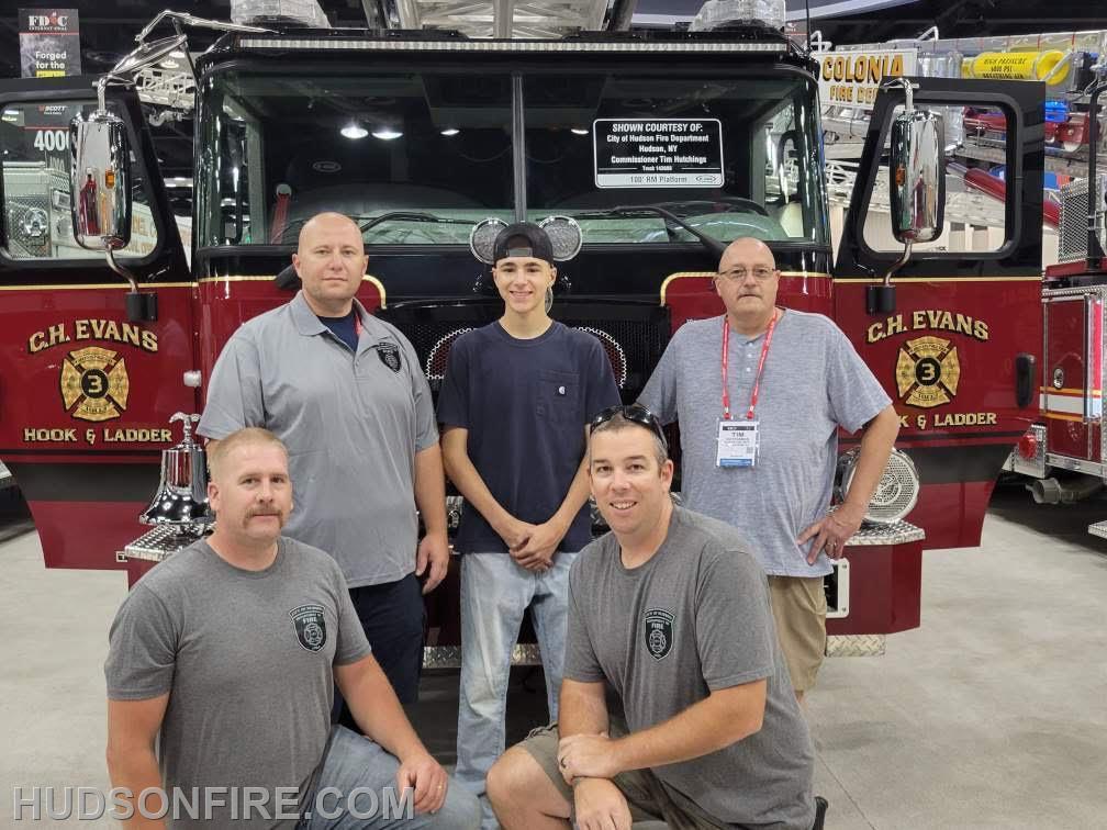 Members of the truck committee pose in front of the new tower ladder. 
